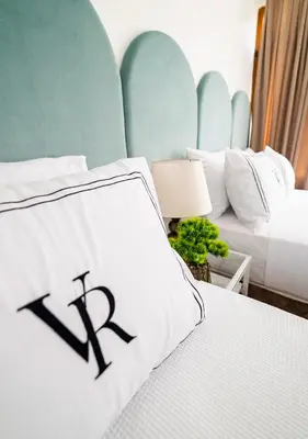 a bedroom with a white bed with a x sign on it at Cheers Hostel in Istanbul