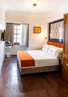 a hotel room with a bed and a window at Cheers Hostel in Istanbul