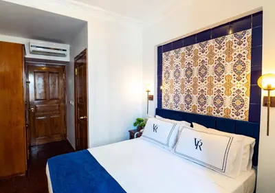 a bedroom with a bed with a blue headboard at Cheers Hostel in Istanbul