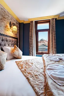 a bedroom with a large bed with a window at Cheers Hostel in Istanbul
