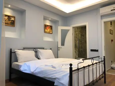 a bedroom with a large bed with white sheets at Cheers Hostel in Istanbul