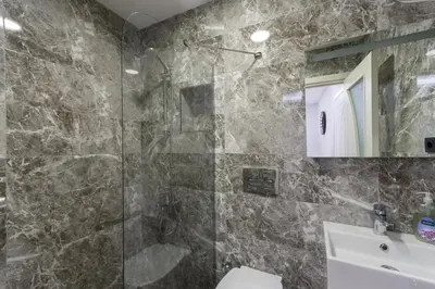 a bathroom with a shower and a sink at Cheers Hostel in Istanbul