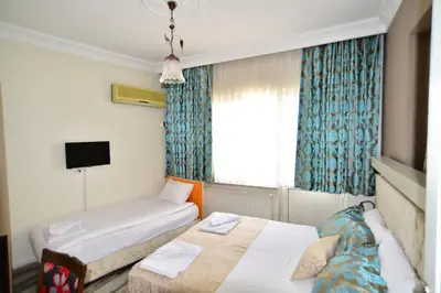 a hotel room with two beds and a window at Hotel Han in Istanbul