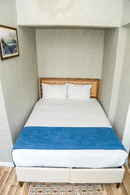 a bedroom with a bed with a blue blanket at Asitane Life Hotel in Istanbul