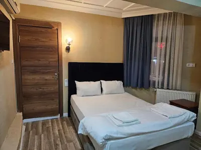 a bedroom with a bed and a window at Asitane Life Hotel in Istanbul