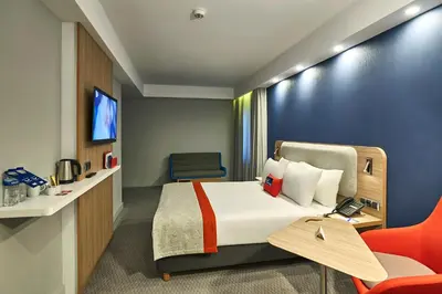 a hotel room with a bed and a chair at Holiday Inn Express - Istanbul - Atakoy Metro by IHG in Istanbul