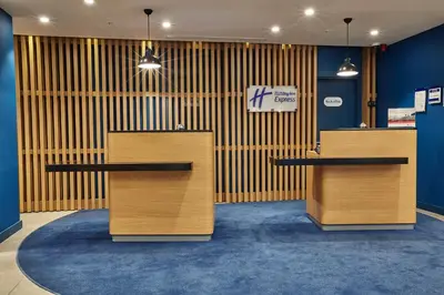 a lobby with two wooden desks in a store at Holiday Inn Express - Istanbul - Atakoy Metro by IHG in Istanbul
