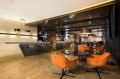 a restaurant with chairs and tables and a bar at DoubleTree By Hilton Istanbul - Old Town in Istanbul