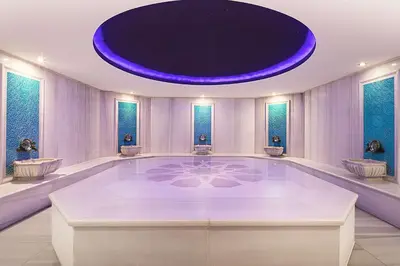 a large room with a large swimming pool with a purple ceiling at DoubleTree By Hilton Istanbul - Old Town in Istanbul