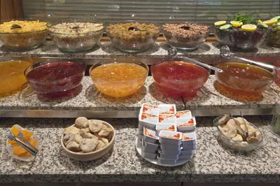 a bunch of bowls of food on a counter at Nanda Hotel in Istanbul