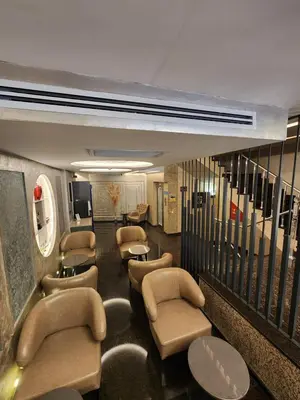 a waiting room with chairs and tables and stairs at Nanda Hotel in Istanbul