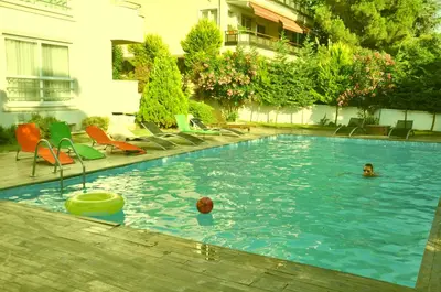 a swimming pool with two people in the water at dragos island hotel in Istanbul