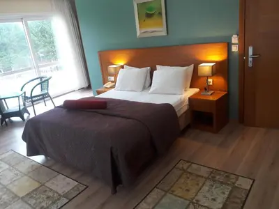 a bedroom with a large bed and a large window at dragos island hotel in Istanbul
