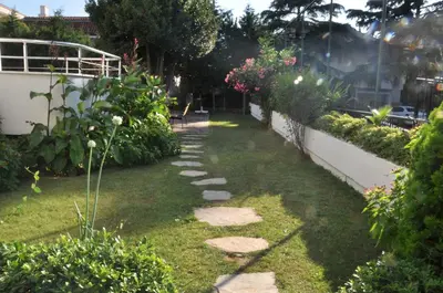 a garden with rocks and plants in a yard at dragos island hotel in Istanbul