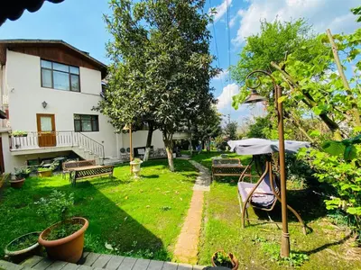 a yard with benches and a house at Butik Hotel Maşukiye in Masukiye