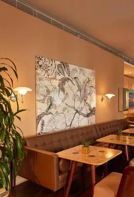 a restaurant with tables and a large painting on the wall at The Stay Nisantasi in Istanbul