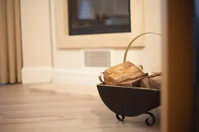 a wheelbarrow filled with wood sitting on a floor at The Escape Hotel in Agva