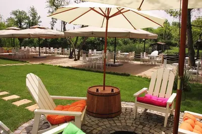 a group of chairs and umbrellas in a park at The Escape Hotel in Agva