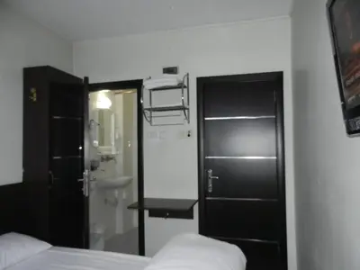 a bedroom with a bed and a sink and a mirror at Cagri Hotel in Istanbul