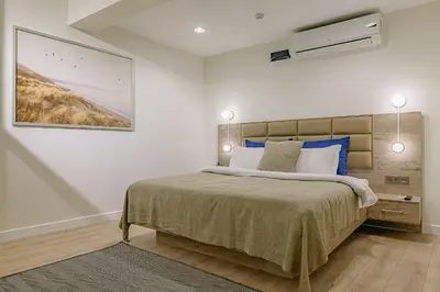 a bedroom with a bed with blue and white pillows at The Wilson Galata Hotel in Istanbul
