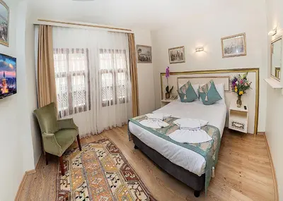 a bedroom with a bed and a chair at Sultan House in Istanbul