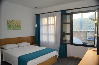 a bedroom with a bed and a large window at Pera Hotel Lüleburgaz in Lüleburgaz