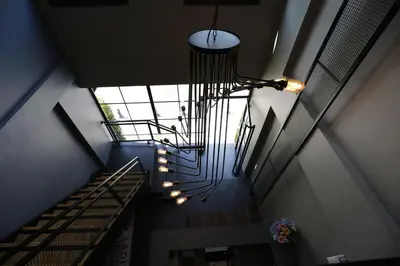 a spiral staircase with a chandelier in a building at Pera Hotel Lüleburgaz in Lüleburgaz