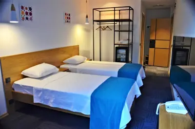 a hotel room with two beds and a mirror at Pera Hotel Lüleburgaz in Lüleburgaz