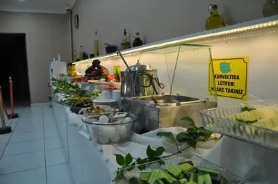 a buffet line with a lot of plants and food at Odrys Beach Hotel & Resort in Tekirdag