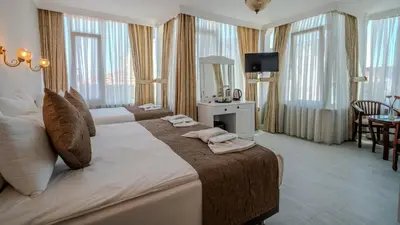 a hotel room with a large bed with towels on it at Sultanahmet Cesme Hotel in Istanbul