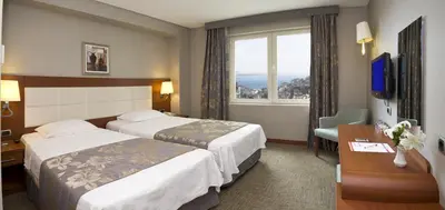 a hotel room with two beds and a window at Innpera Hotel in Istanbul