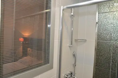 a bathroom with a shower with a glass door at Golden Siyav Hotel in Istanbul