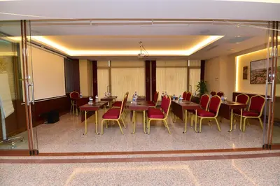 a conference room with tables and red chairs at Golden Siyav Hotel in Istanbul