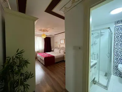 a hotel room with a bed and a glass doorway at Le Safran Suite Hotel in Istanbul