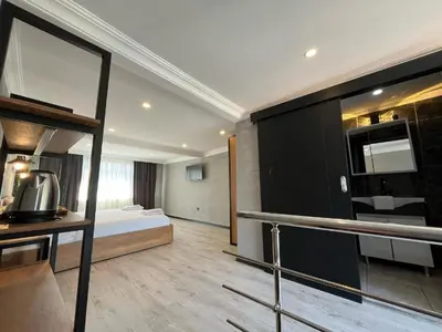a hotel room with a bed and a kitchen at Le Safran Suite Hotel in Istanbul