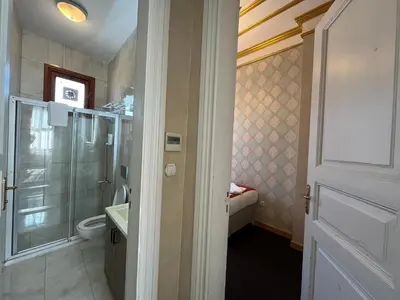 a bathroom with a shower and a toilet and a sink at Le Safran Suite Hotel in Istanbul