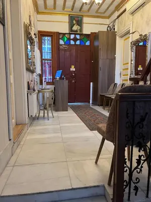 a hallway with a door and a table and chairs at Le Safran Suite Hotel in Istanbul