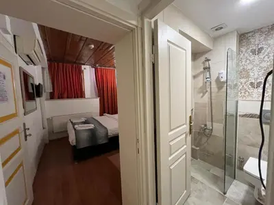 a room with a shower and a bed and a bathroom at Le Safran Suite Hotel in Istanbul