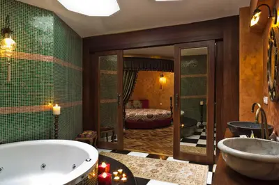a bathroom with a bath tub and a bedroom at Sokullu Pasa Hotel - Special Class in Istanbul
