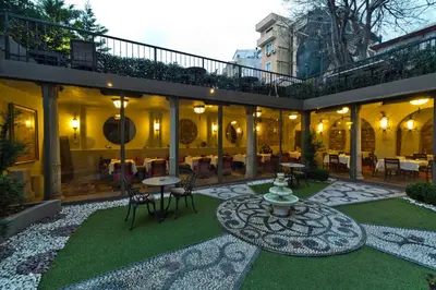 a courtyard with a fountain and tables and chairs at Sokullu Pasa Hotel - Special Class in Istanbul