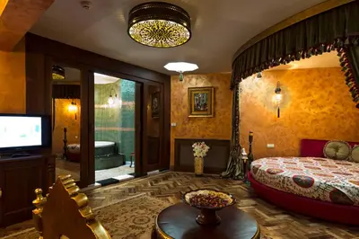 a bedroom with a bed and a tv and a tub at Sokullu Pasa Hotel - Special Class in Istanbul