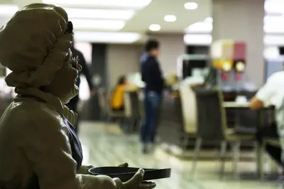 a statue of a woman holding a plate in an office at Benler Otel Laleli ISTanbul in Istanbul
