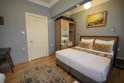 a bedroom with a bed and a table in it at Topkapi Apartments in Istanbul