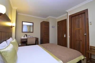 a hotel room with a bed and a desk at Grand Gebze Hotel in Gebze