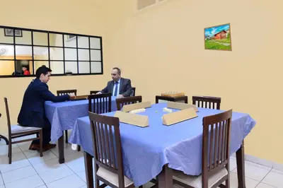 two men sitting at a table in a restaurant at Grand Gebze Hotel in Gebze