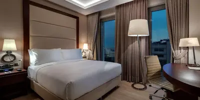 a hotel room with a bed and a desk and a desk at Doubletree By Hilton Istanbul Topkapi in Istanbul
