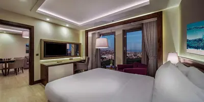 a hotel room with a bed and a large window at Doubletree By Hilton Istanbul Topkapi in Istanbul