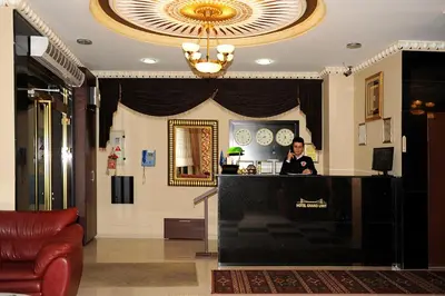 a man sitting at a counter in a lobby at Hotel Grand Umit in Istanbul
