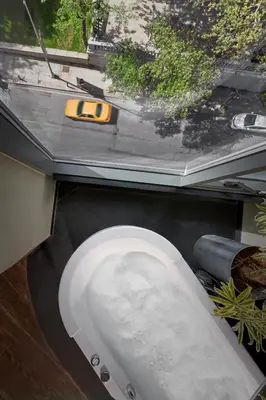 a white toilet sitting on the ground with a yellow handle at Gezi Hotel Bosphorus, Istanbul, a Member of Design Hotels in Istanbul