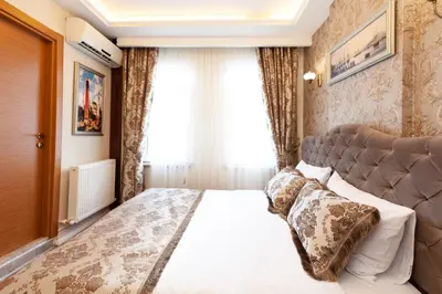 a bedroom with a large bed in front of a window at Rose Mansion by Otantik Suites in Istanbul